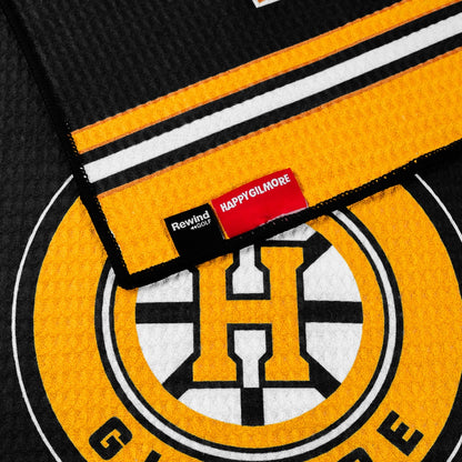 Black performance golf towel with yellow stripes and a Happy Gilmore Hockey logo.
