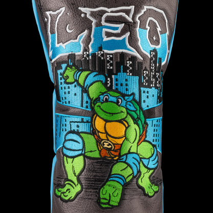 Blue TMNT Leo driver cover with swords and city backdrop.