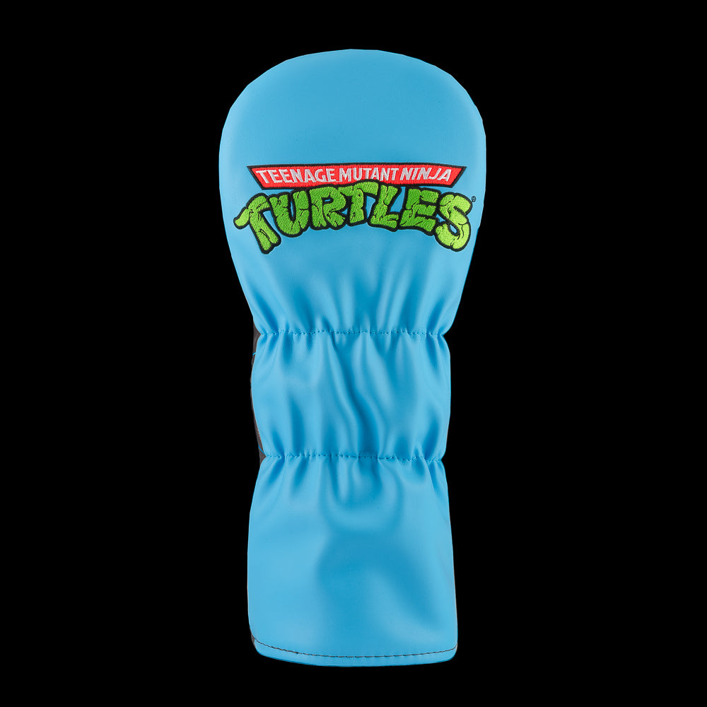 Blue TMNT Leo driver cover with swords and city backdrop.