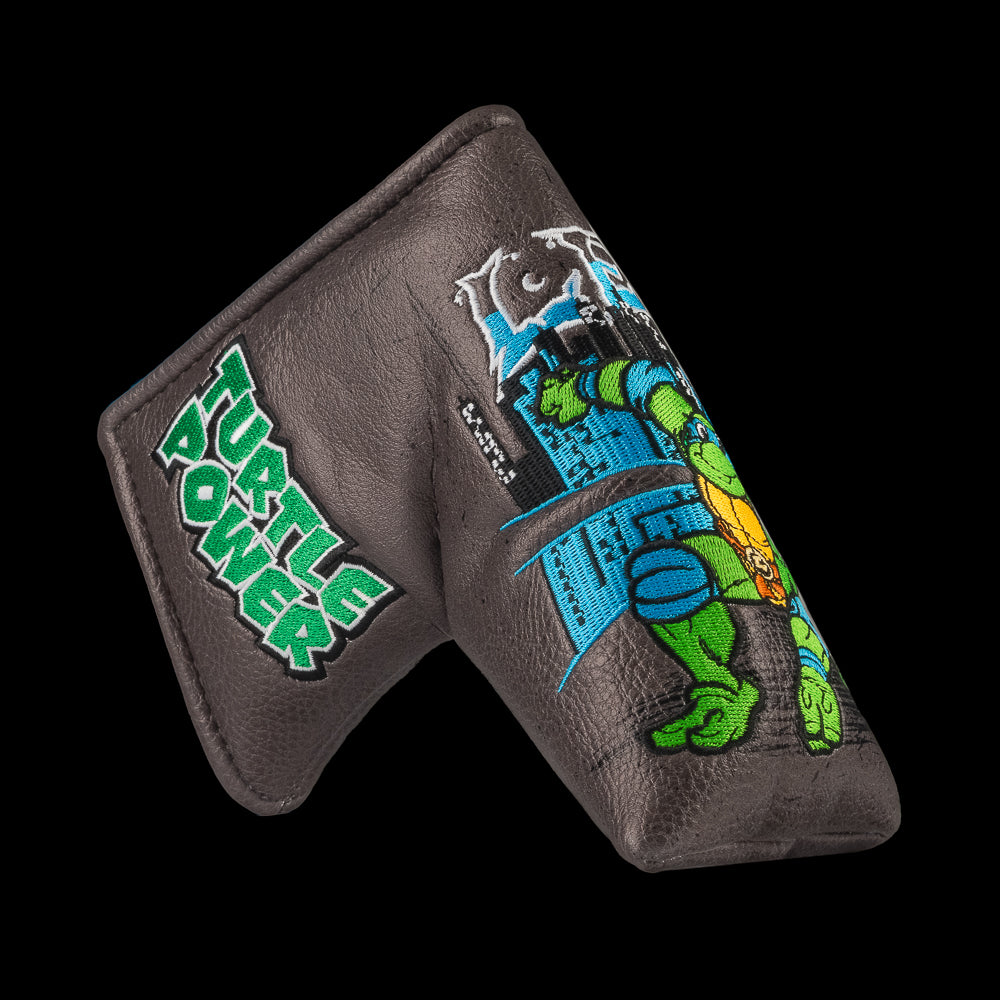 TMNT Leo blade putter cover with swords and blue cityscape detailing.