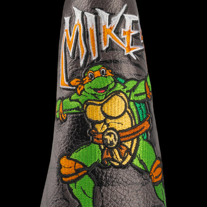 TMNT Mikey blade putter cover with neon green details, bold cartoon design, and Teenage Mutant Ninja Turtles style.