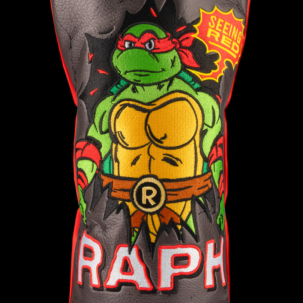 Red TMNT Raph driver cover with bold sai design.