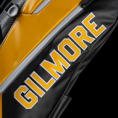 Yellow and black golf bag with 'Gilmore' branding on a white background