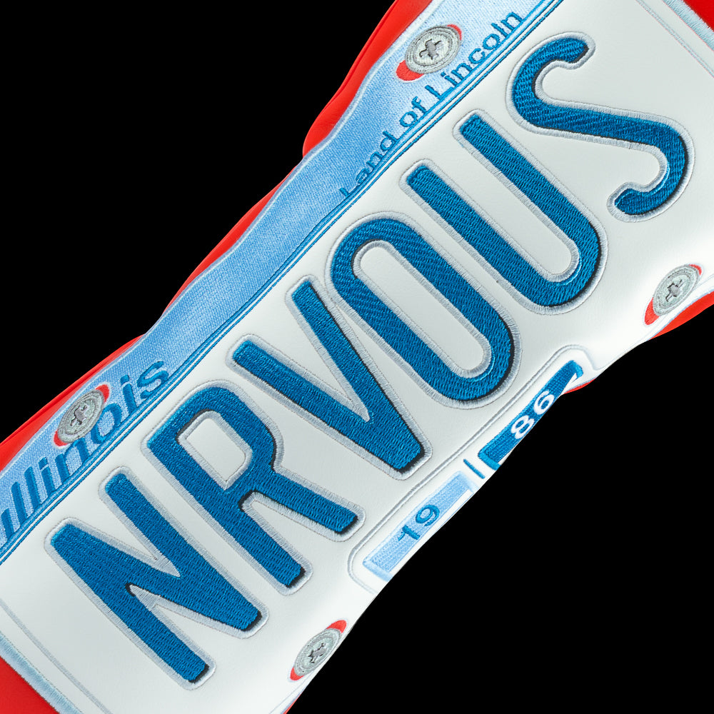 Rewind Golf x Ferris Bueller's Day Off official NRVOUS 1986 IL license plate on red material. 