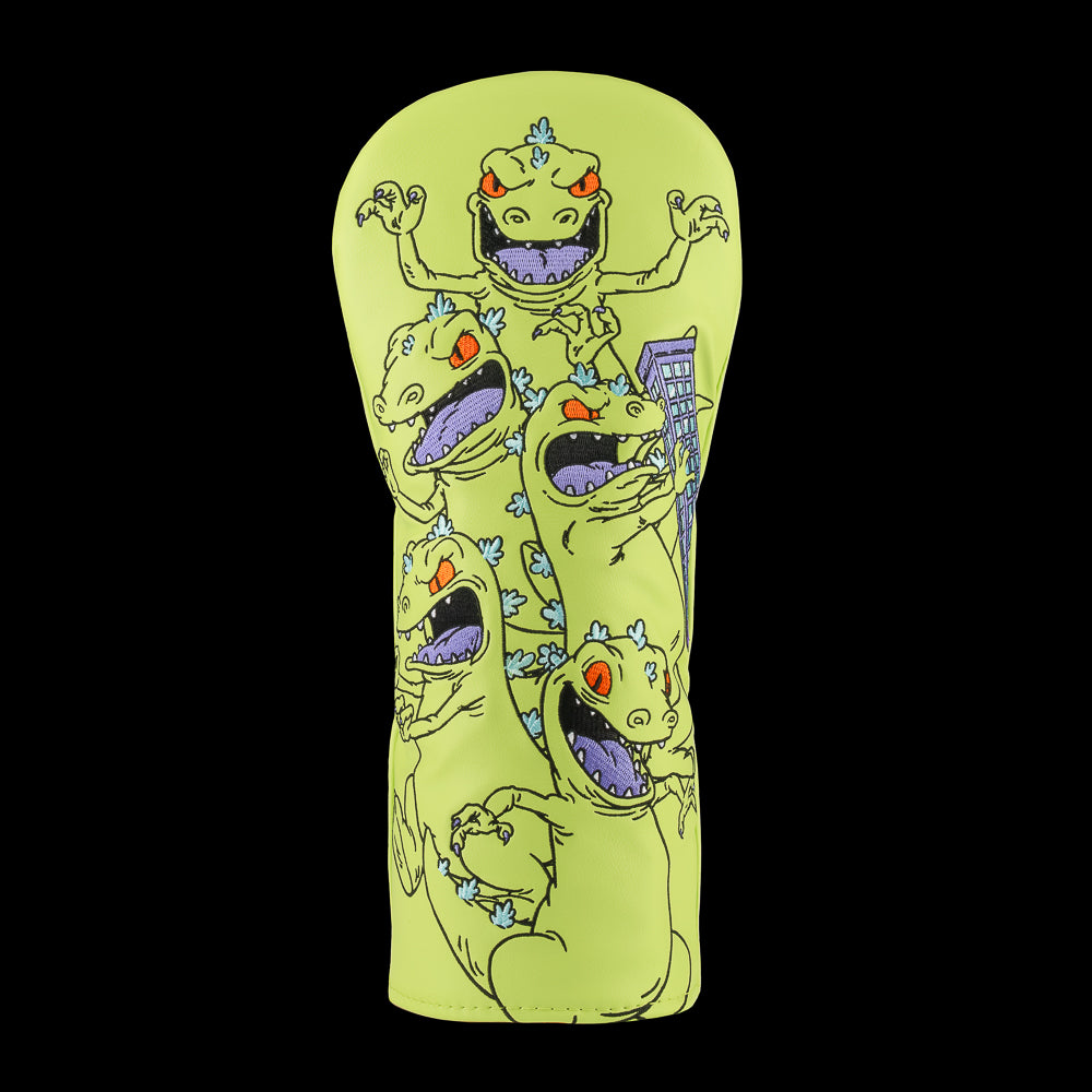 Green Rugrats Reptar driver cover with stacked cartoon Reptar design holding a building, bold Rewind Golf headcover style.