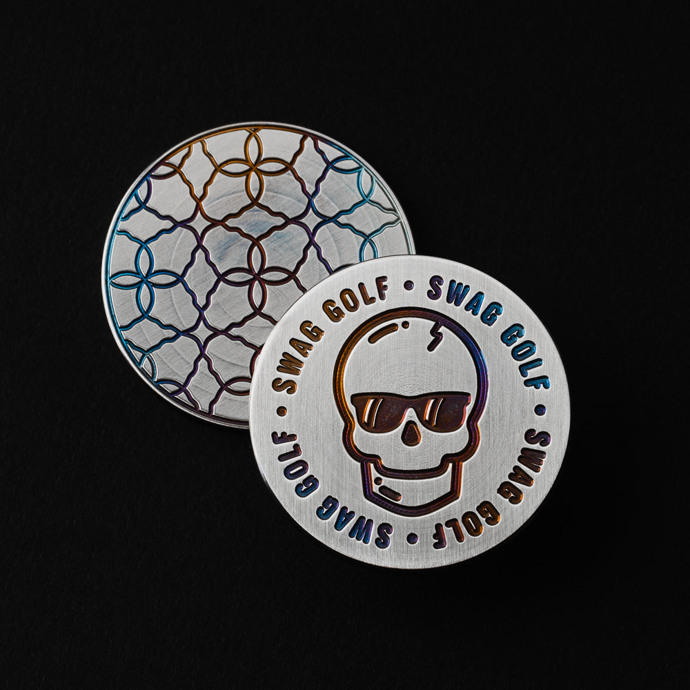 Swag Golf round stainless steel golf ball marker accessory with skull engravings.