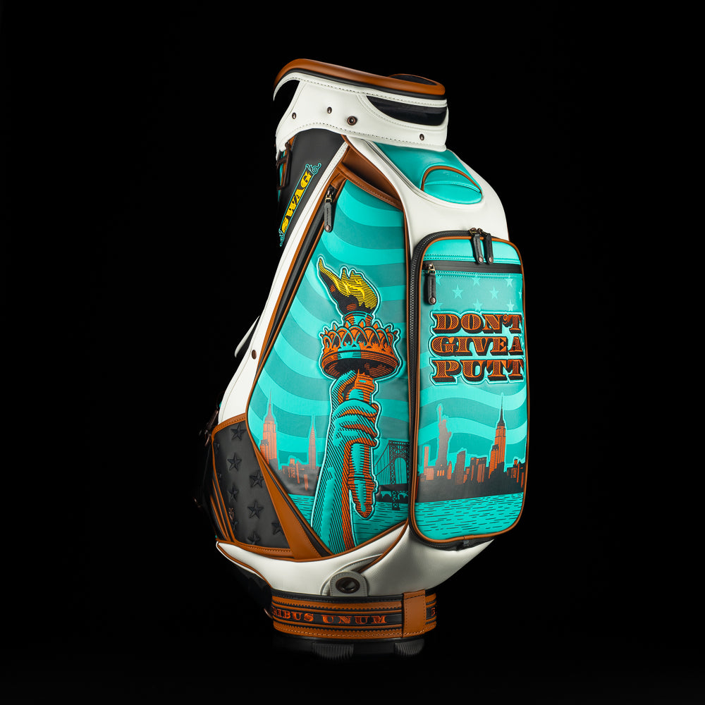 SWAG x Vessel golf bag with Statue of Liberty design and 'Don't Give a Putt' text on a black background