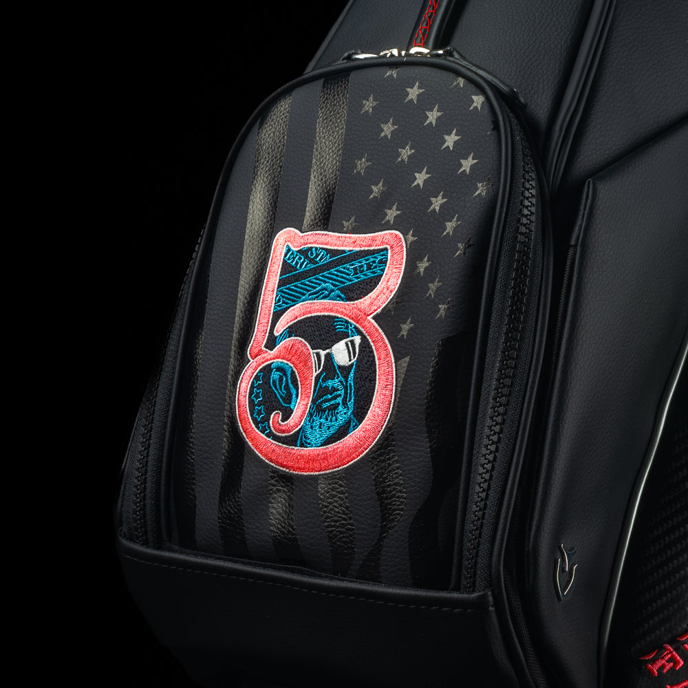 SWAG Golf USA 2025 Lincoln dollar bill themed Vessel black stand bag with currency themed embroidery.