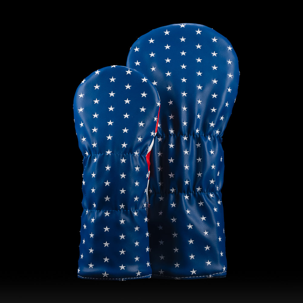 Two blue golf club covers with white star patterns on a black background