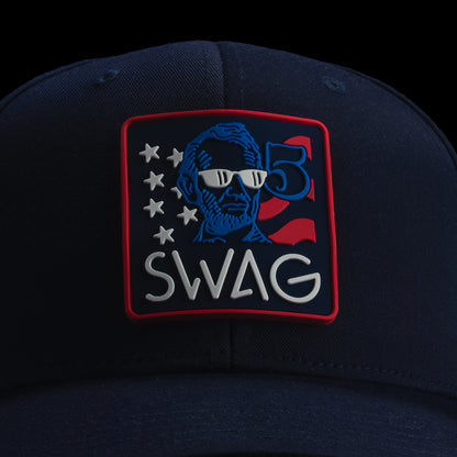 Navy blue cap with a colorful 'SWAG' patch featuring a cartoon character on a black background