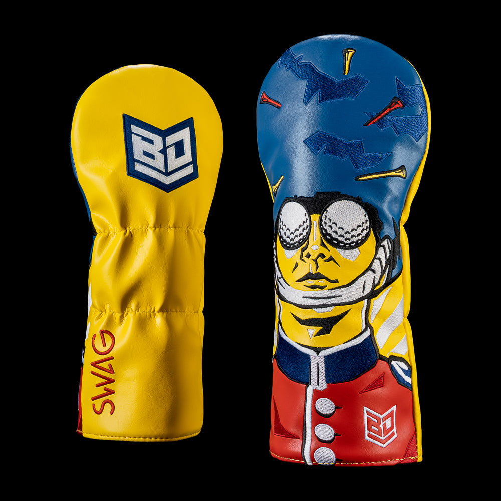 King's Guard Driver Cover featuring a British royal guard with golf ball eyes in red, navy, and yellow alongside a yellow panel with Bryson DeChambeau sheild branding.