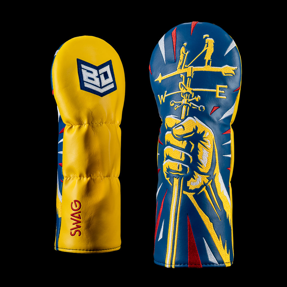 Weathervane fairway wood cover featuring a hand holding a weather vane against a bold red, navy, yellow, and white graphic background with Bryson DeChambeau shield branding.
