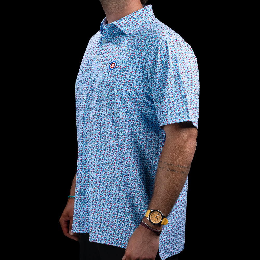 Side view of the Chicago Cubs World Champs Classic Polo Shirt featuring the all-over blue, red, and white pattern.