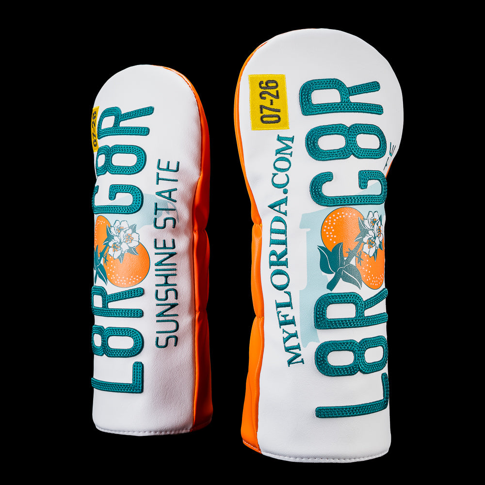 Side view of the Florida Later Gator driver headcover showing the Florida license plate inspired design with vertical "L8R G8R" lettering, illustrated oranges, "Sunshine State" text, and orange side panels.