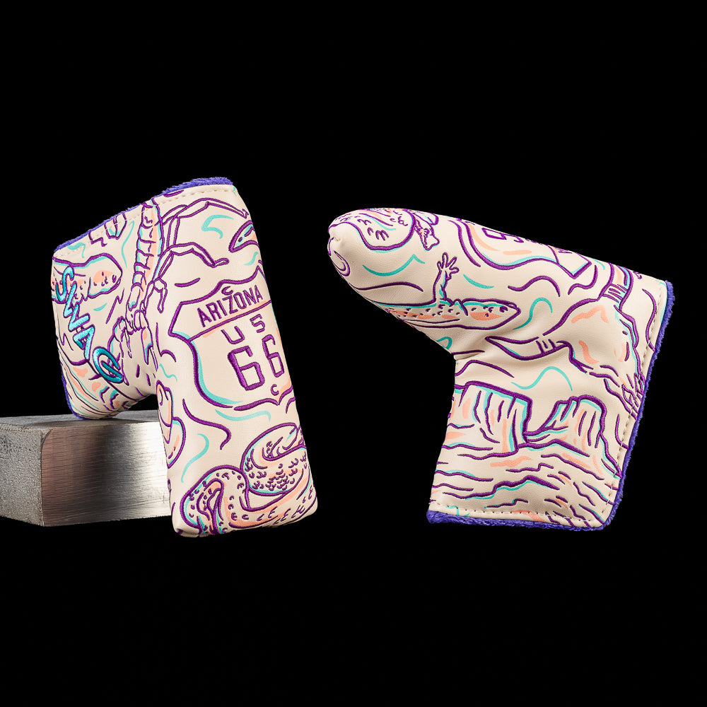 Arizona blade putter cover featuring embroidered Route 66 highway shield artwork with saguaro cacti, desert wildlife, canyon landscapes, and Arizona inspired illustrations in purple, teal, and cream.
