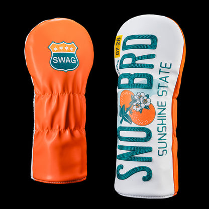 Florida driver headcover featuring a Florida license plate inspired design with oversized "SNO BRD" lettering, "Sunshine State" text, a July 26 registration sticker, and bright orange side panels. Back features an orange panel with the SWAG shield logo.