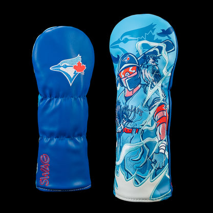 SWAG Golf Toronto Blue Jays fairway cover shown front and back with an embroidered Blue Jays logo on the reverse and detailed artwork of a Blue Jays batter surrounded by blue jays, swirling wind, and team graphics.