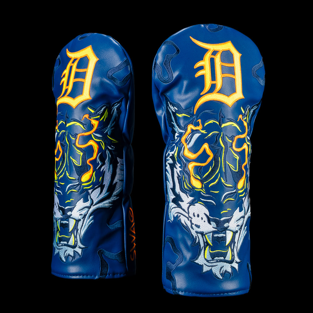 Multiple angled views of the Detroit Tigers Night Prowl Driver Cover highlight the embroidered white tiger artwork beneath the oversized "D" logo. The navy cover features flame detailing, neon orange and yellow accents.