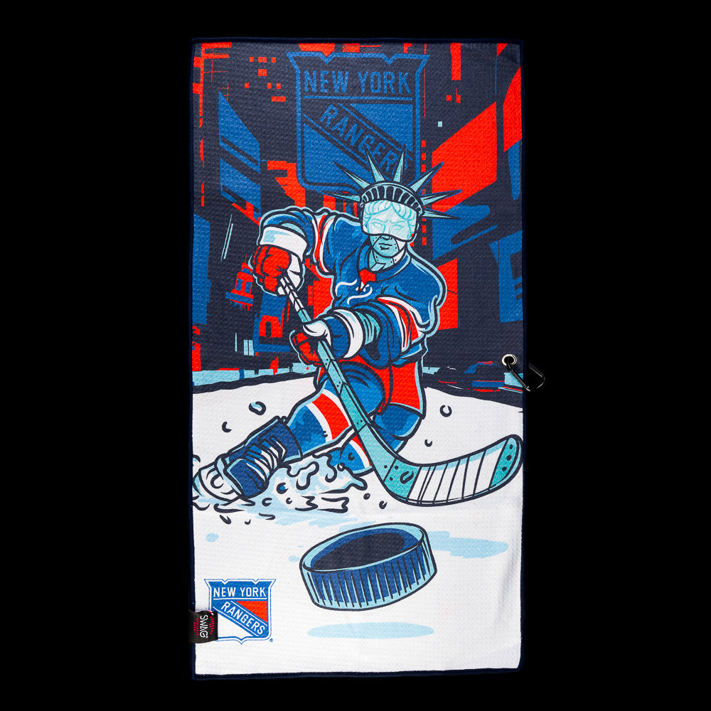 Blue, red and white New York Rangers golf towel with a hockey player, city backdrop, Rangers shield and oversized puck.
