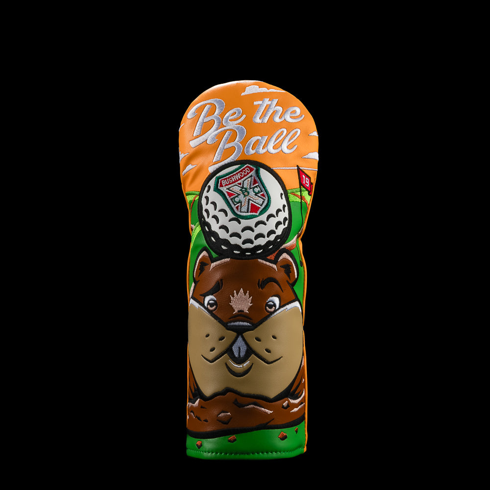 An orange and green golf fairway club headcover featuring a Caddyshack cartoon beaver face, a golf ball graphic, and the text 'Be the Ball' on a solid black background.