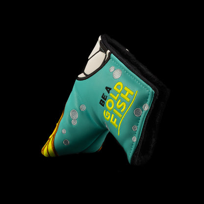 A turquoise and orange golf blade putter cover featuring a cartoon fish design and the text 'BE A GOLDFISH' on a solid black background. Officially licensed Ted Lasso design from Rewind Golf.