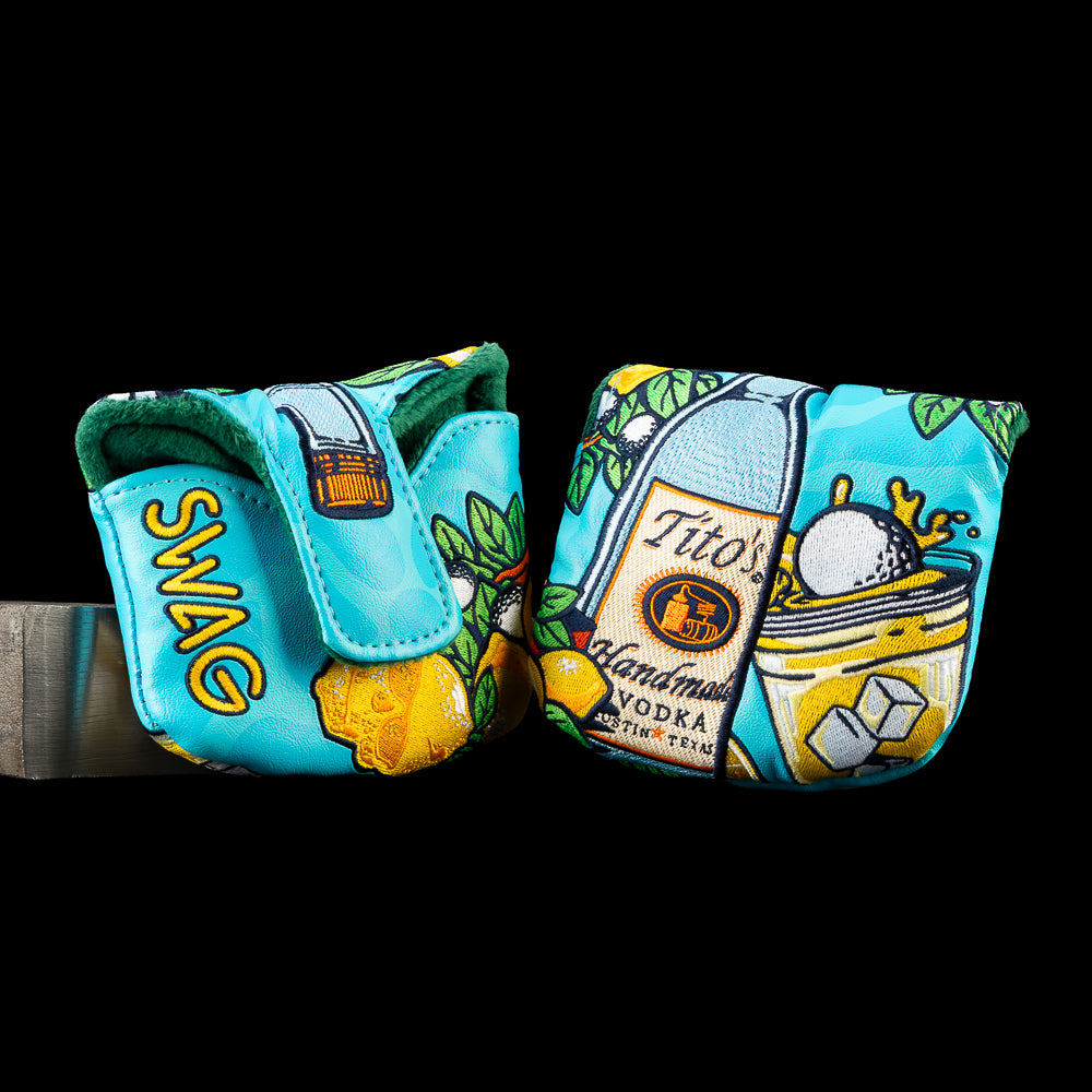 SWAG Golf Titos & Lemonade mallet putter cover featuring a Tito's Vodka, a golf ball splashing into a cocktail, ice cubes, lemons, leaves, and bold turquoise inspired by the classic summer drink.