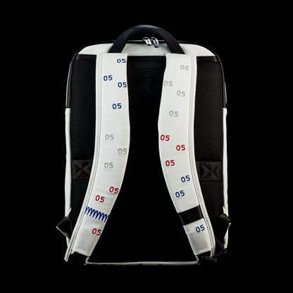 Back view of the RWB Gigantic Lincoln Backpack featuring padded adjustable shoulder straps, breathable back panel, and hanging loop.