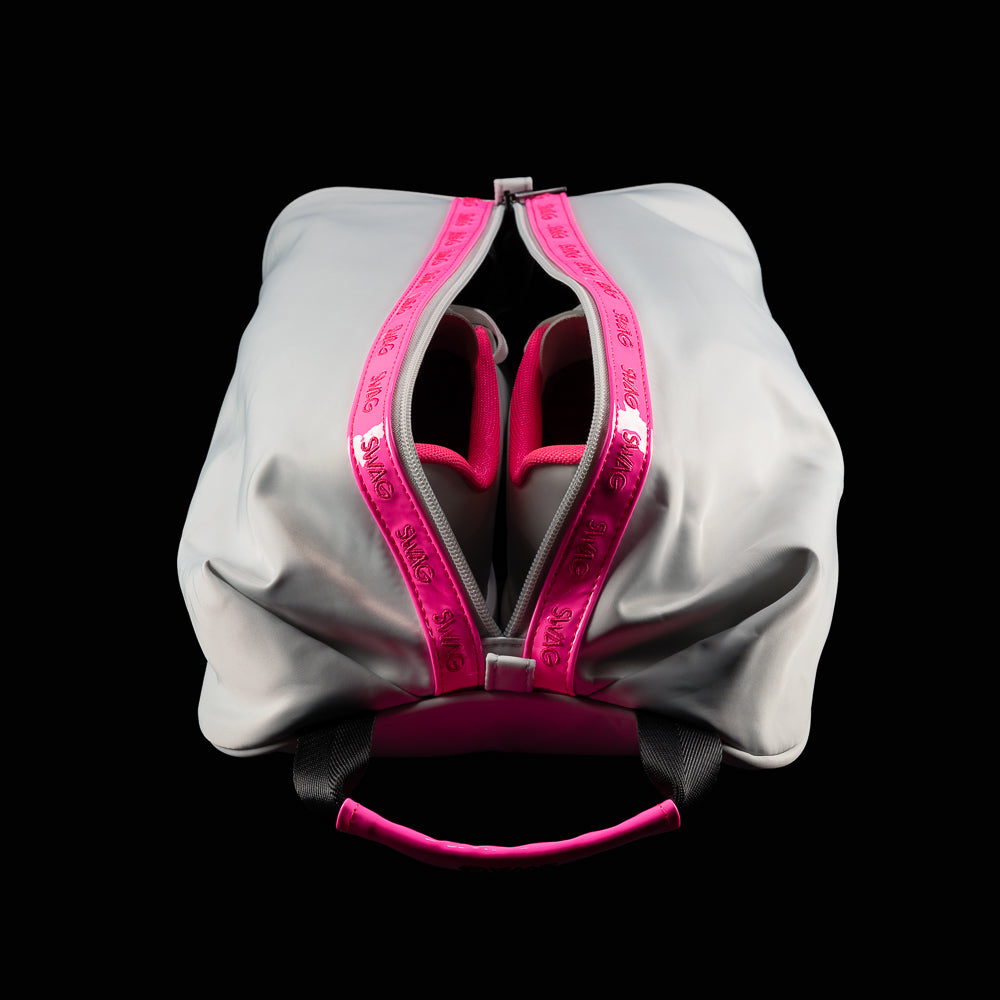 Top-down view of open SWAG Golf shoe bag showing dual shoe compartments with black interior lining and zipper accents.
