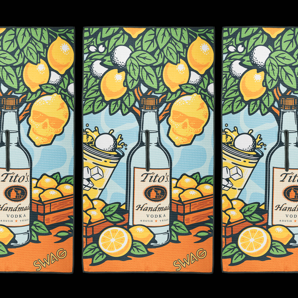 Tito's x SWAG golf towel featuring lemon artwork, Tito's bottle graphics, citrus slices, and bright summer-inspired design.
