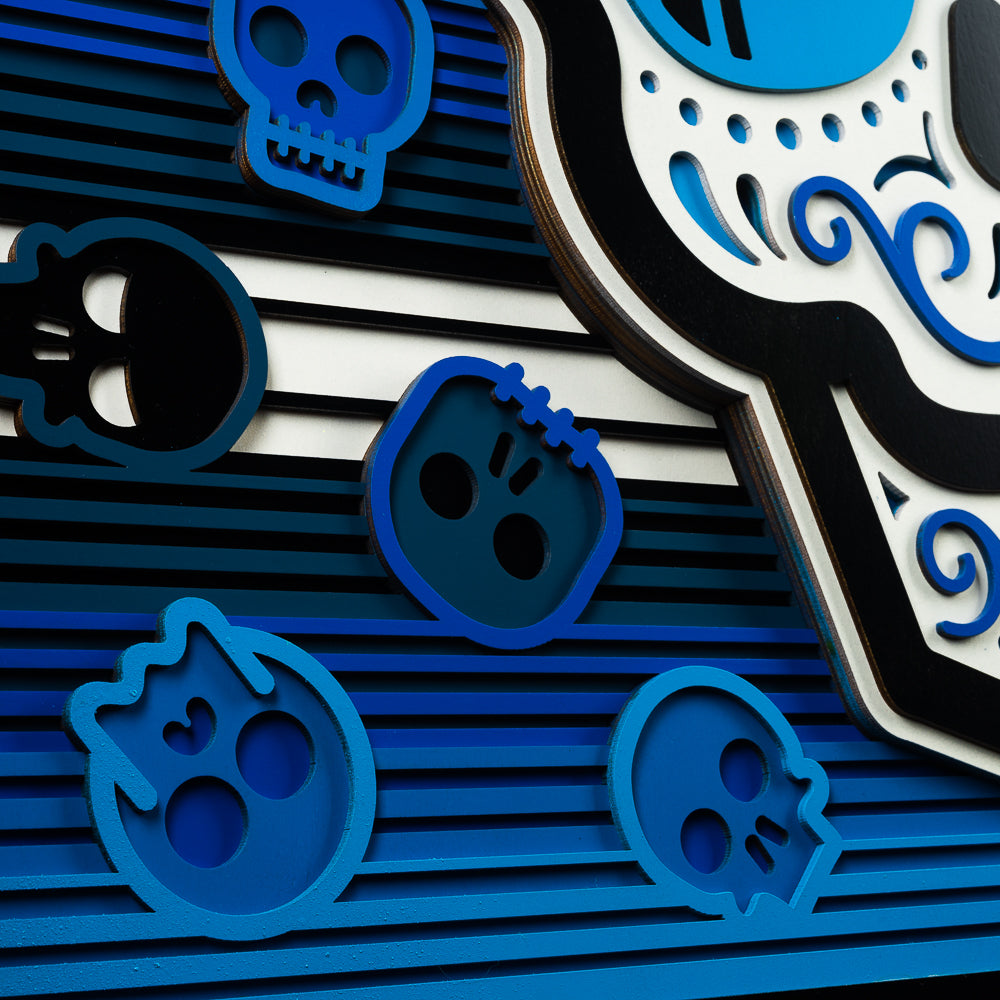 Swag x Andre Kaut wood art panel serape sugar skull themed in blue, white and black.