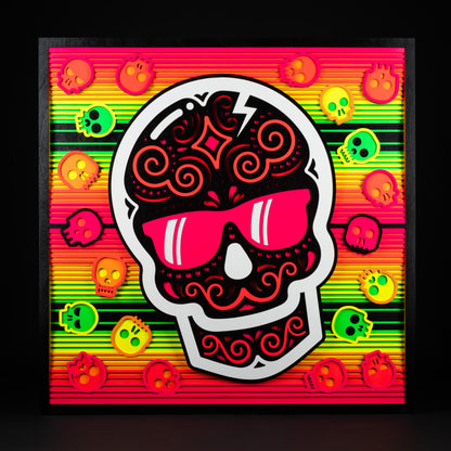 Swag x Andre Kaut wood panel artwork serape sugar skull themed in neon green, pink, orange, yellow and black.