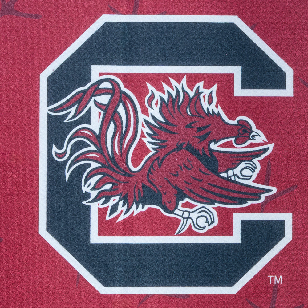 Red golf towel with University of South Carolina Gamecocks football player graphic and logo on a black background