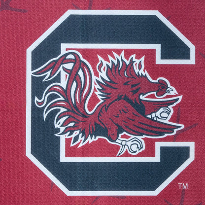 Red golf towel with University of South Carolina Gamecocks football player graphic and logo on a black background