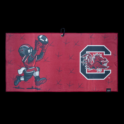 Red golf towel with University of South Carolina Gamecocks football player graphic and logo on a black background
