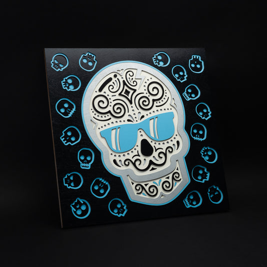 Swag x Andre Kaut multi-layer 19x19 wood panel artwork featuring a black, white and blue sugar skull.