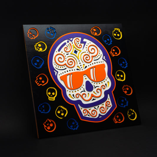 Swag x Andre Kaut multi-layer 19x19 wood panel artwork featuring a black, white, yellow, orange and purple sugar skull.