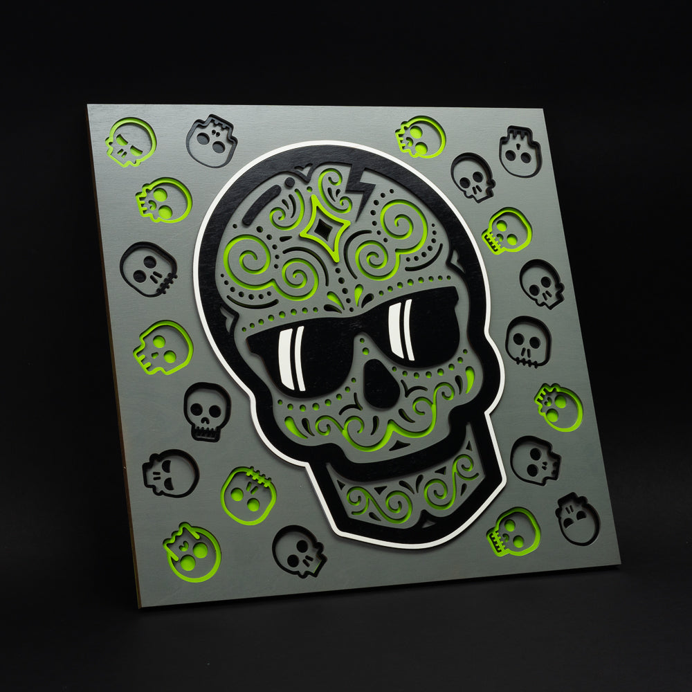 Swag x Andre Kaut multi-layer 19x19 wood panel artwork featuring a gray, green, and black sugar skull.