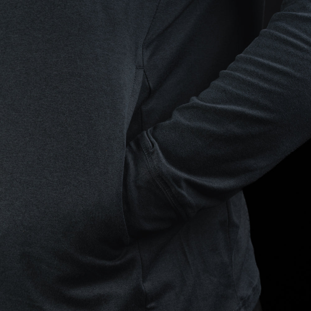 Person wearing a navy long-sleeve hoodie with a United States of SWAG logo on the chest against a black background