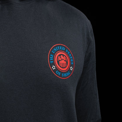 Person wearing a navy long-sleeve hoodie with a United States of SWAG logo on the chest against a black background