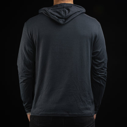 Person wearing a navy long-sleeve hoodie with a United States of SWAG logo on the chest against a black background
