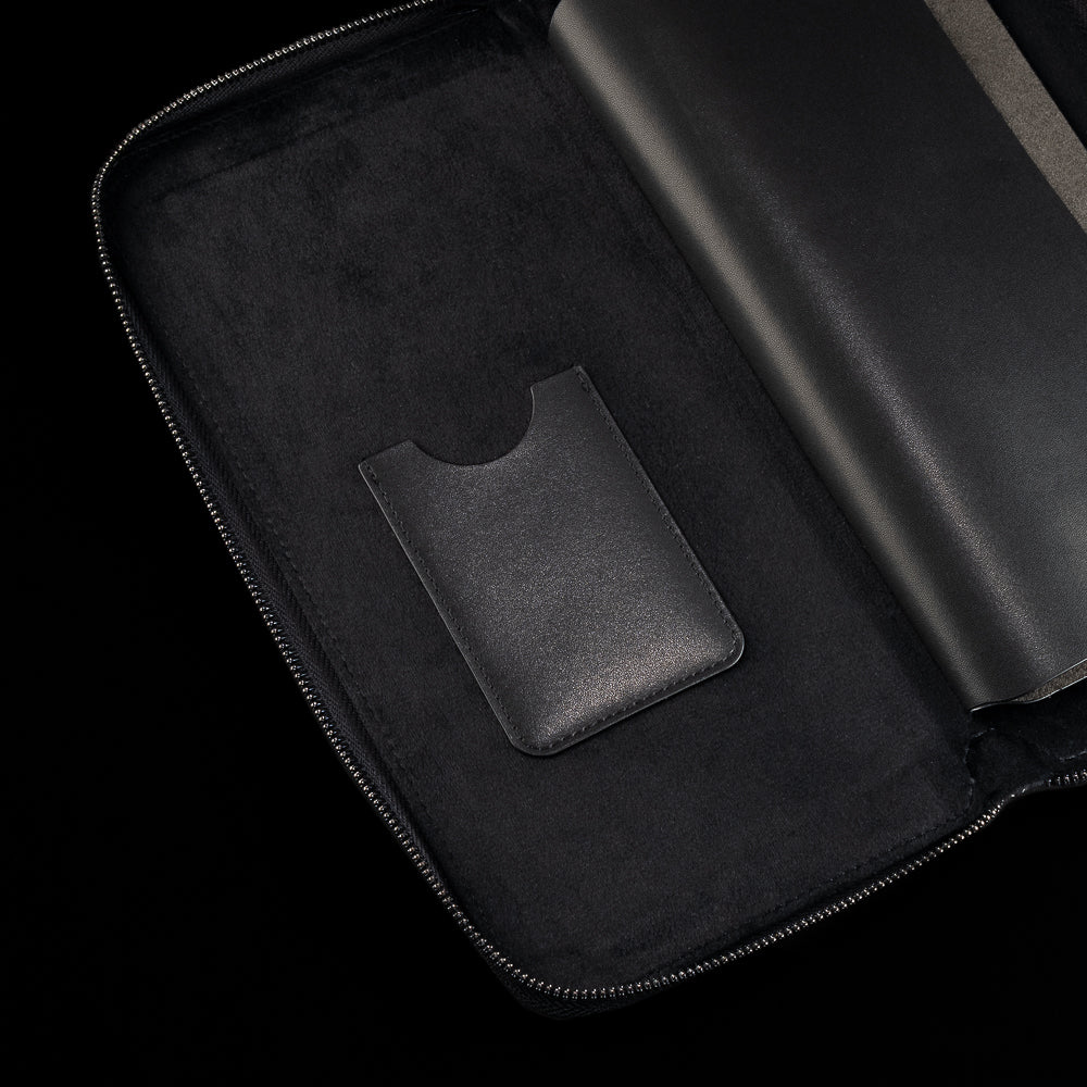 Interior detail of black SWAG Golf glove folio featuring suede lining and built-in accessory storage pocket.