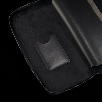 Interior detail of black SWAG Golf glove folio featuring suede lining and built-in accessory storage pocket.
