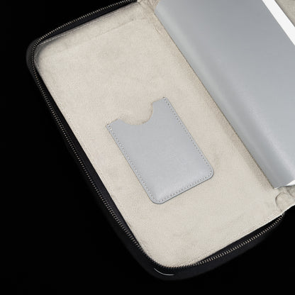 Interior detail of white SWAG Golf glove folio featuring suede lining and built-in accessory storage pocket.