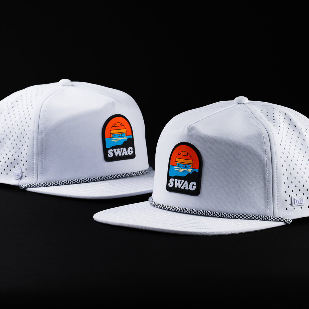 Melin x Swag white snapback performance golf hat with Sunset skull patch.