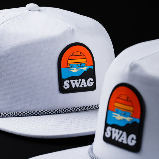Melin x Swag white snapback performance golf hat with Sunset skull patch.