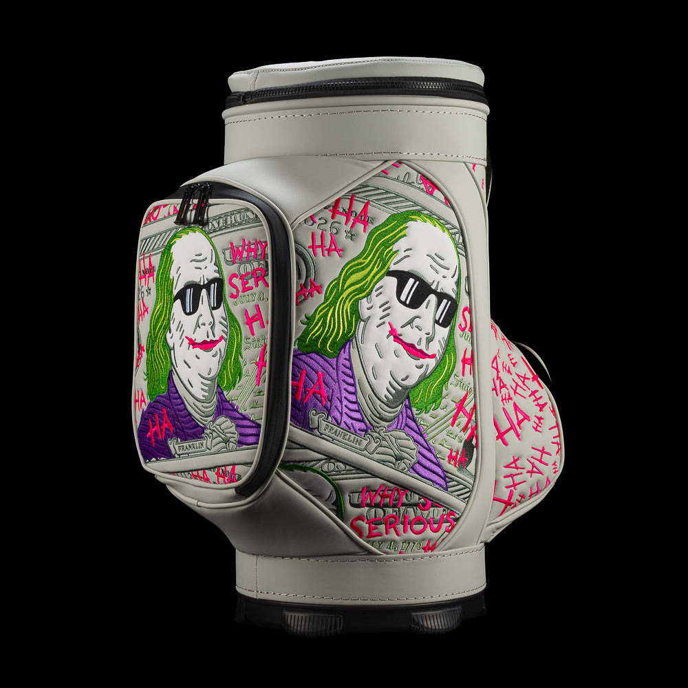 Angled view of SWAG Golf Defaced Franklin Den Caddy Cooler showing illustrated pockets and hot-pink graffiti.