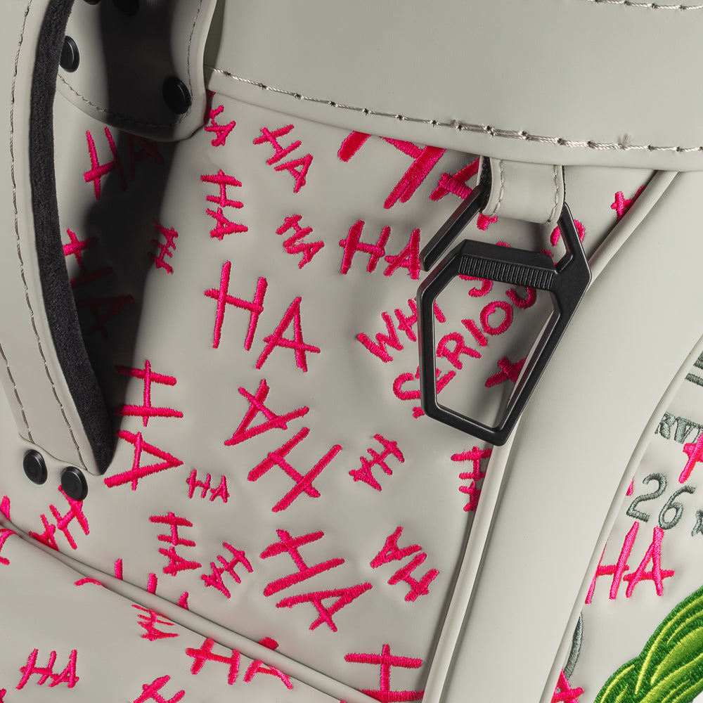 Close-up of Defaced Franklin Den Caddy Cooler showing carry strap, zipper, and pink graffiti on pale-green panels.