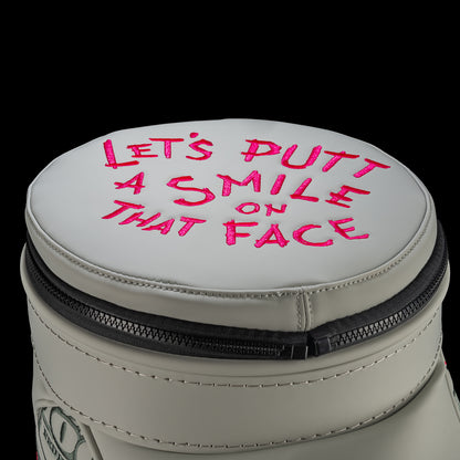 Defaced Franklin Den Caddy Cooler lid with pink “Let’s putt a smile on that face” lettering.