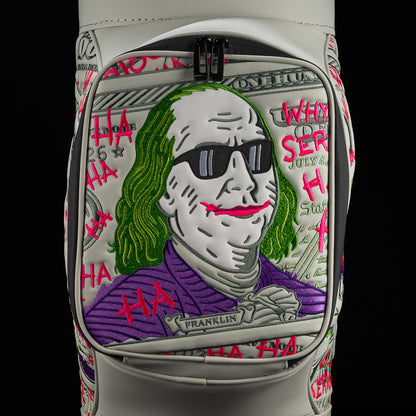Close-up of Defaced Franklin Den Caddy Cooler pocket with currency artwork, green hair, black sunglasses, and a pink grin.