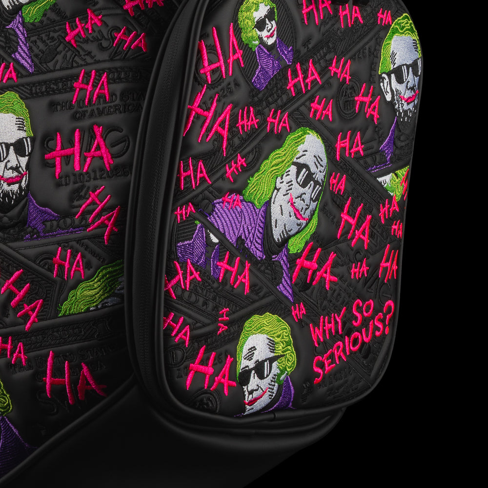 Close-up of Defaced Dollar Bills Den Caddy Cooler pocket with green-haired currency portraits, purple accents, and pink graffiti.